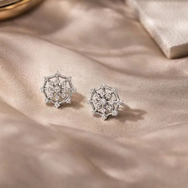 Gold Stud Earrings with Snowflake Motif and Zirconia